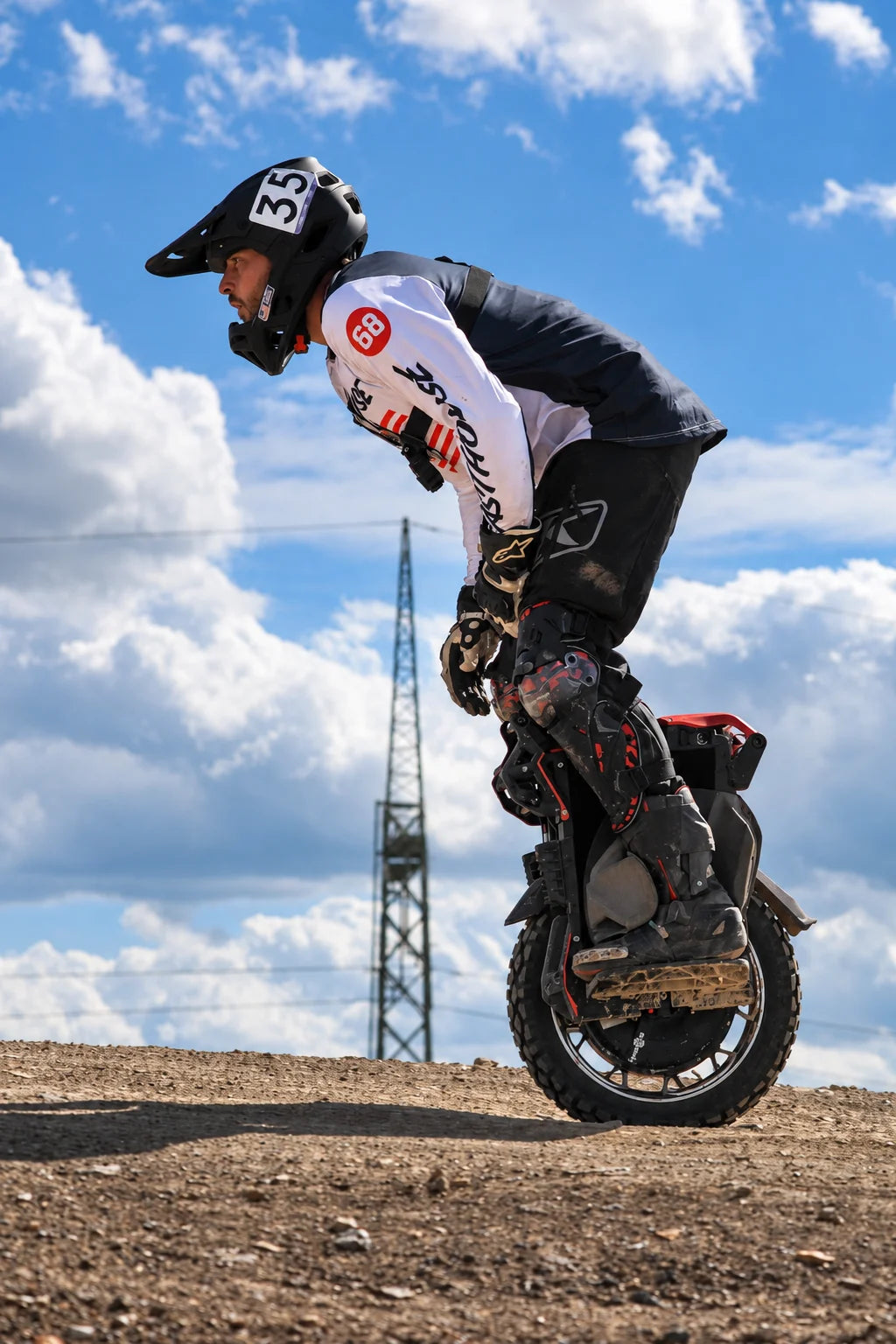 EUC rider in protective gear on a Czech dirt course